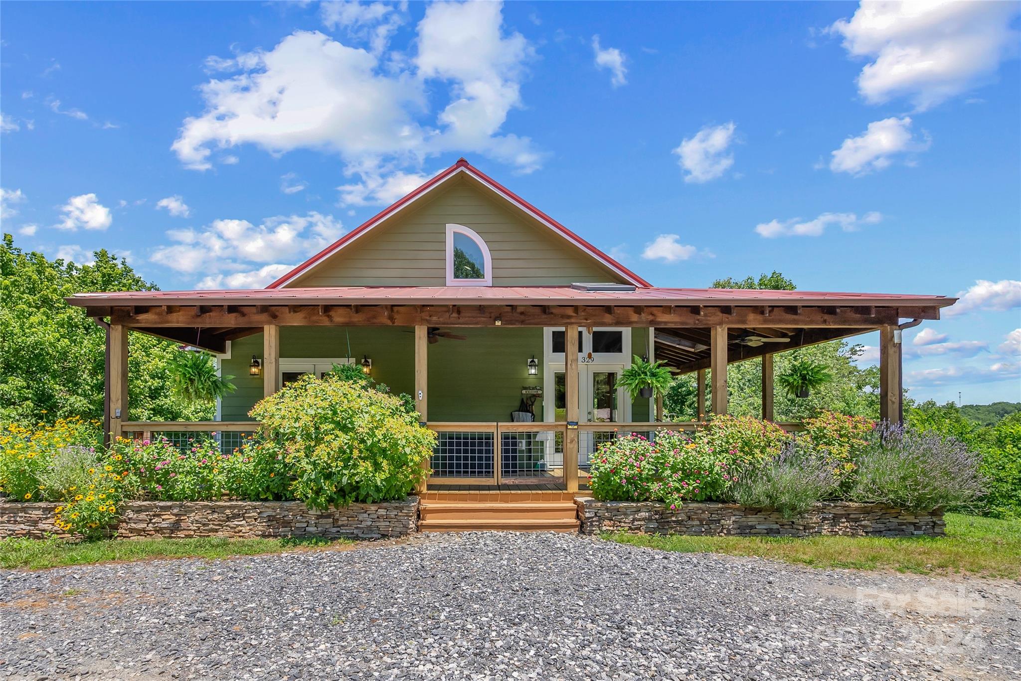 329 Cabin Hollow Drive Marshall, NC 28753 - Photo 5 of 40 a front view of a house with a yard