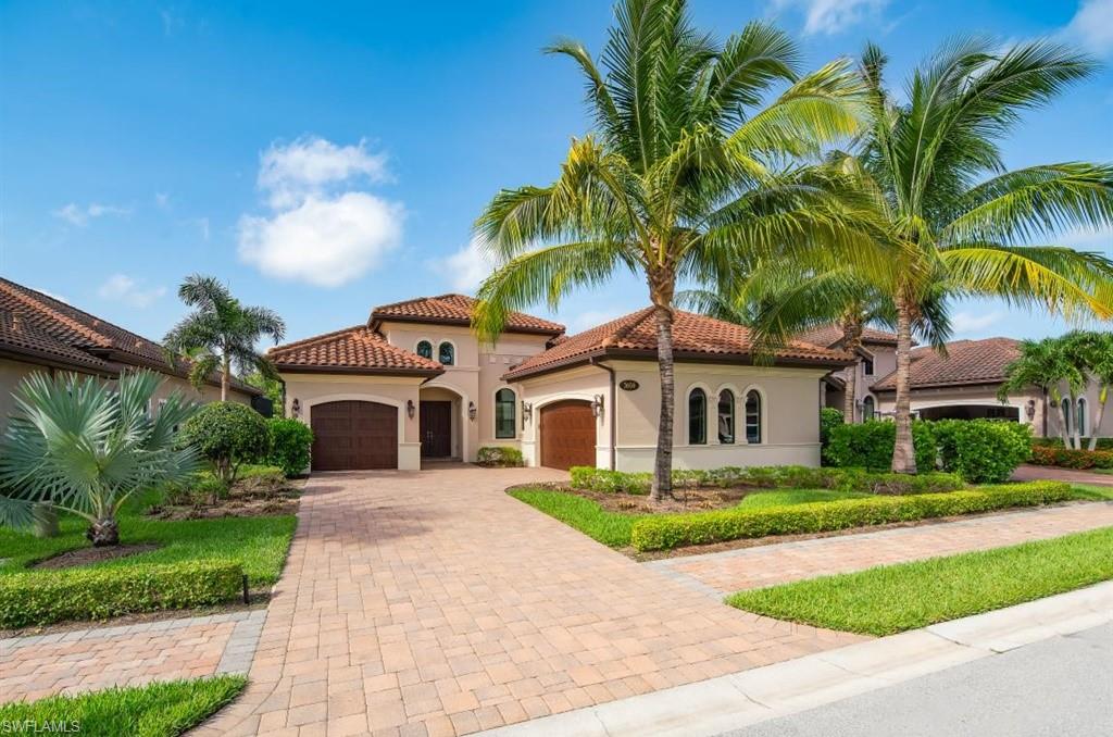 a front view of a house with a garden and trees