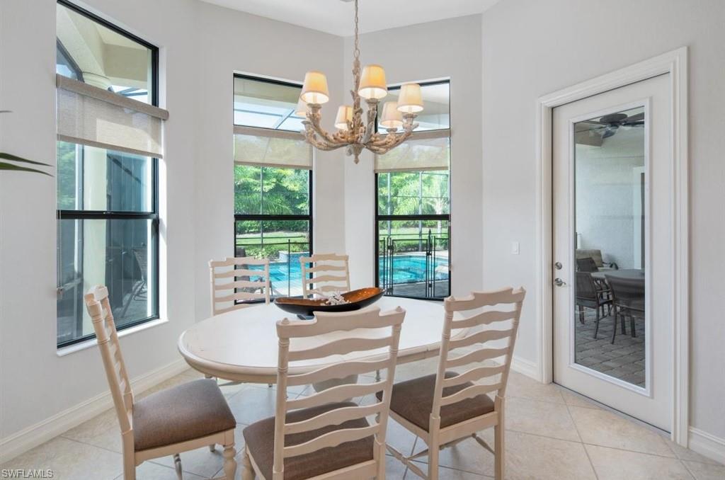7606 Trento Circle Naples, FL 34113 - Photo 11 of 28 a dining room with furniture a chandelier and window
