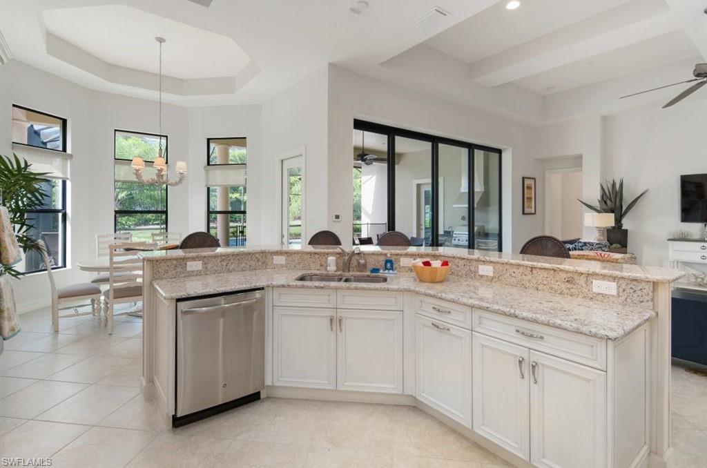 7606 Trento Circle Naples, FL 34113 - Photo 13 of 28 a view of double vanity sink a mirror a window and a lamp