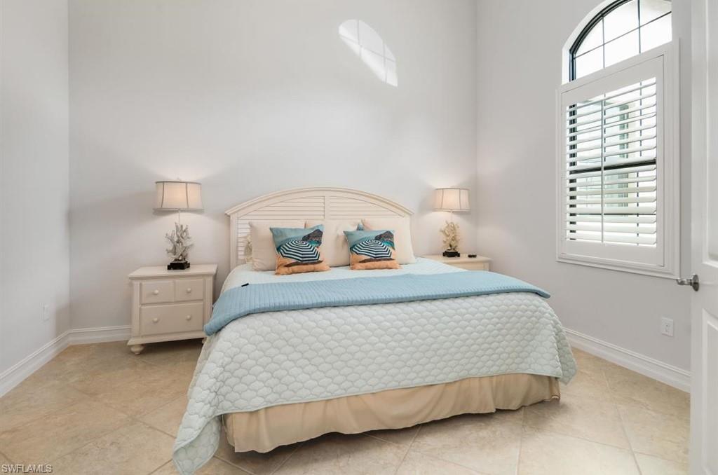 7606 Trento Circle Naples, FL 34113 - Photo 18 of 28 a bedroom with a bed and window