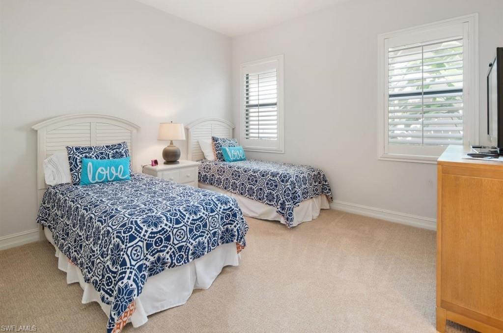 7606 Trento Circle Naples, FL 34113 - Photo 20 of 28 a bed sitting in a bedroom next to a window