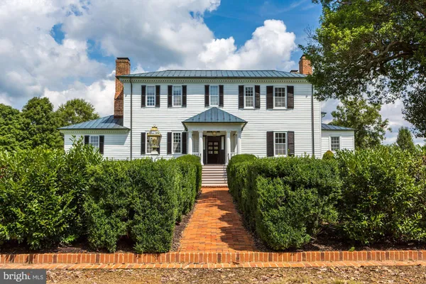 a view of an entryway wooden floor and a chandelier