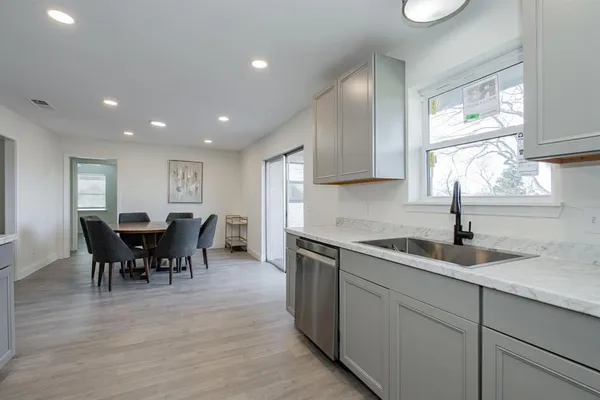 a kitchen with sink and cabinets