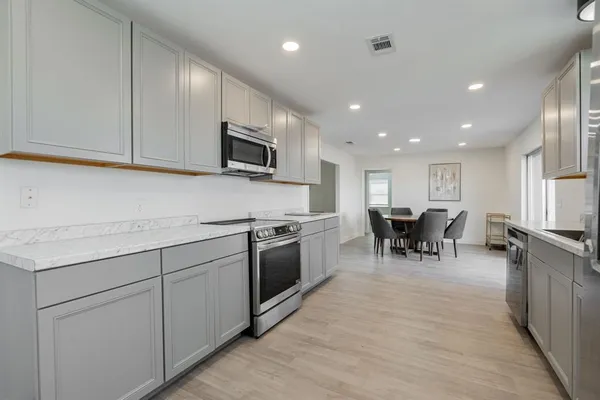 a kitchen with sink cabinets and stainless steel appliances