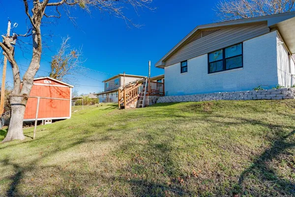 a backyard of a house with table and chairs