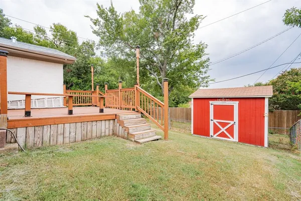 a view of backyard with deck and outdoor seating
