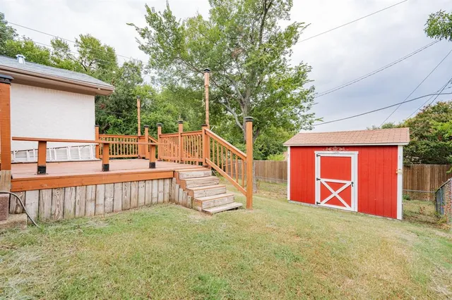 a view of backyard with deck and outdoor seating