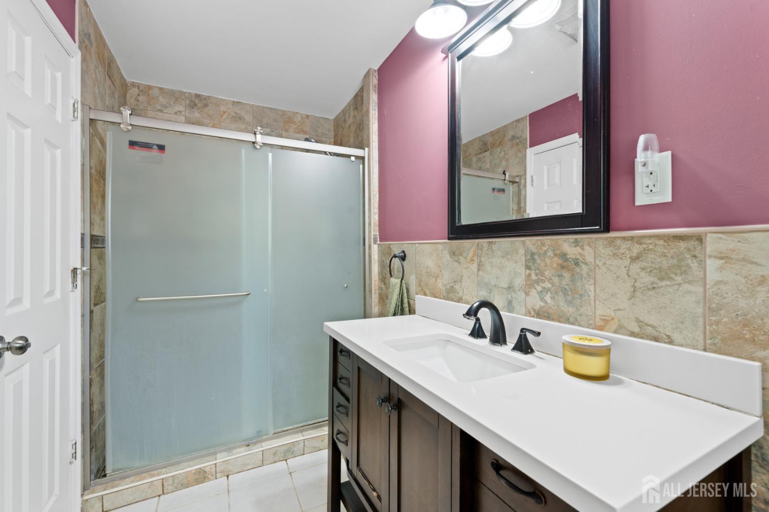 13 Fishel Road Edison, NJ 08820 - Photo 14 of 31 a bathroom with a sink and a mirror