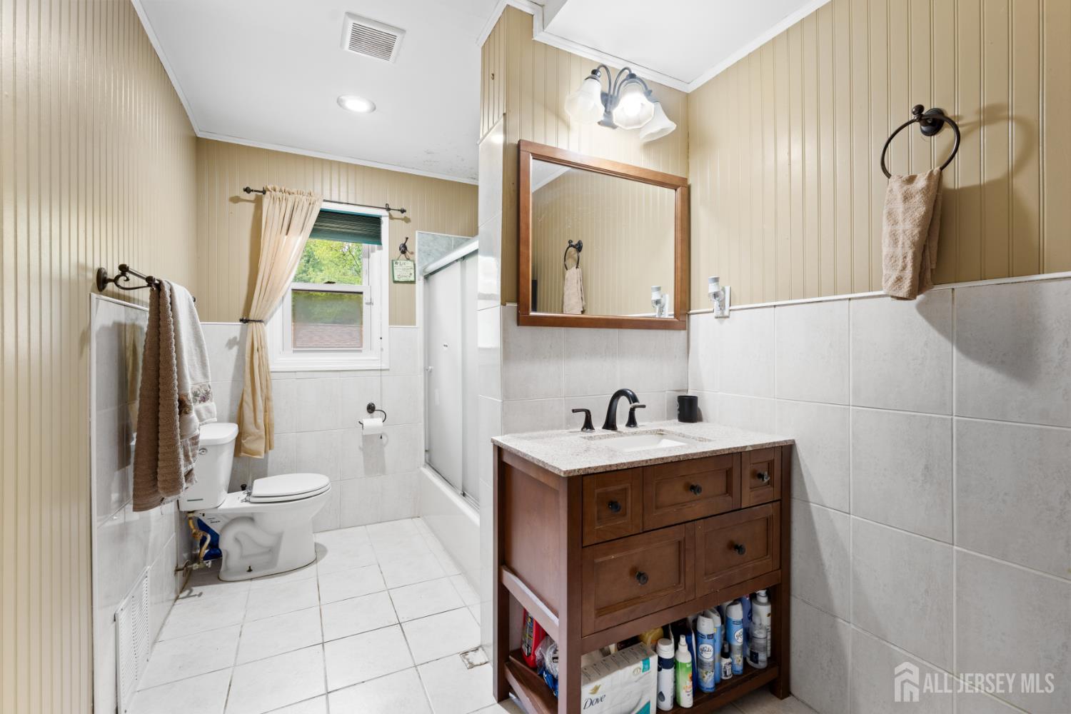 13 Fishel Road Edison, NJ 08820 - Photo 16 of 31 a bathroom with a sink a toilet and shower