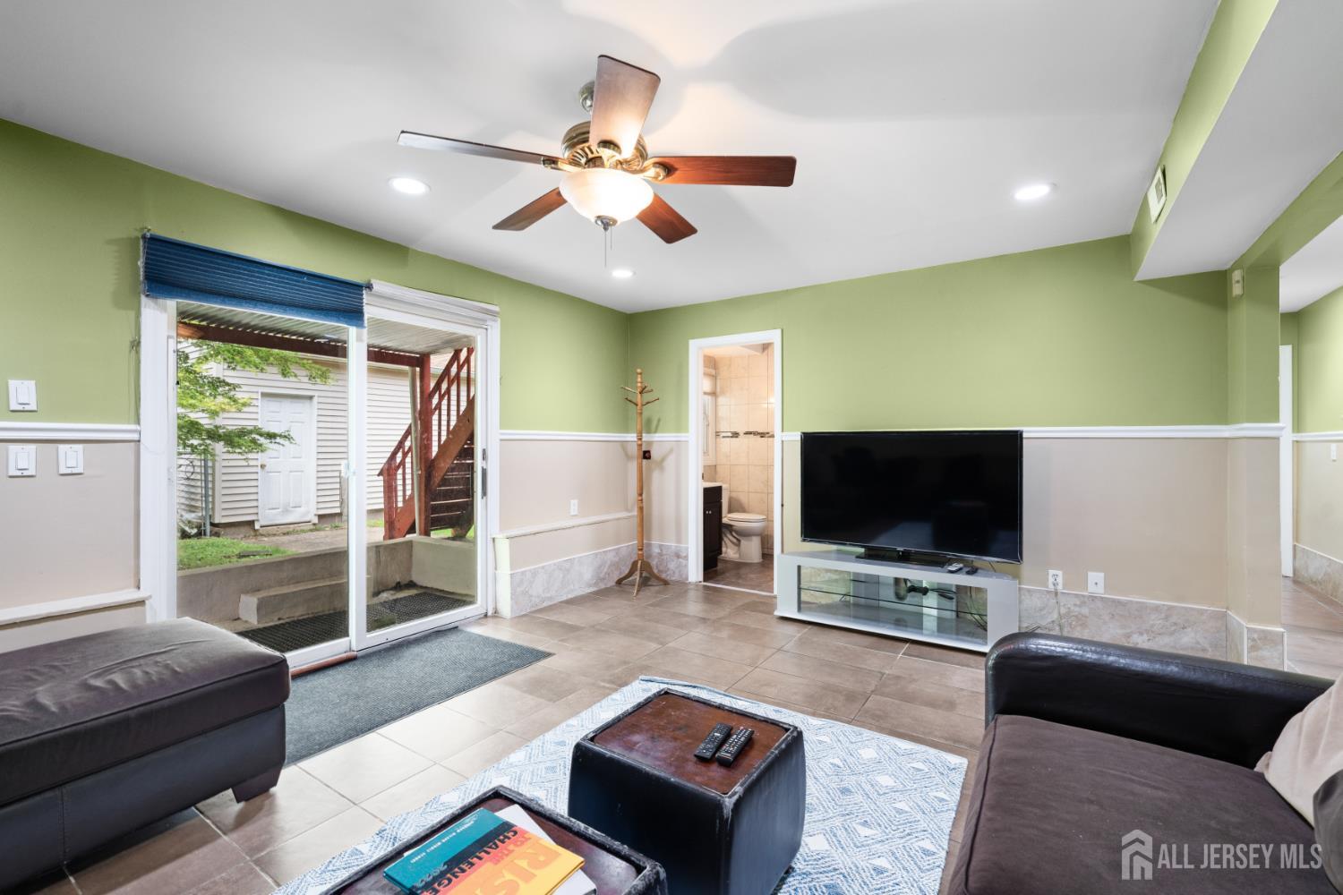 13 Fishel Road Edison, NJ 08820 - Photo 19 of 31 a living room with furniture and a flat screen tv