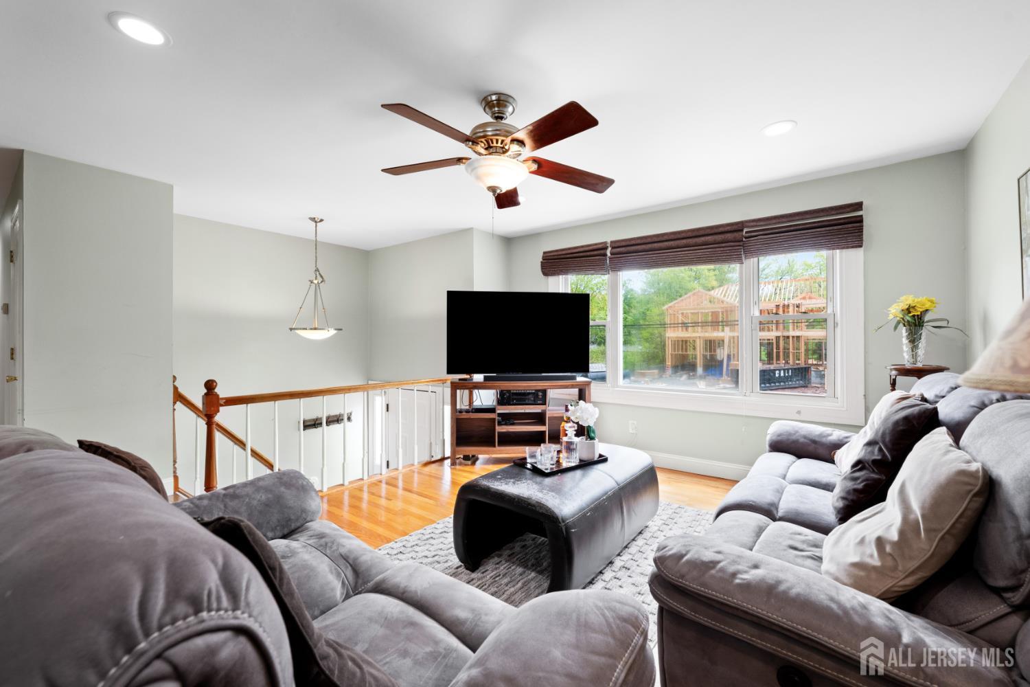 13 Fishel Road Edison, NJ 08820 - Photo 5 of 31 a living room with furniture a flat screen tv and a large window