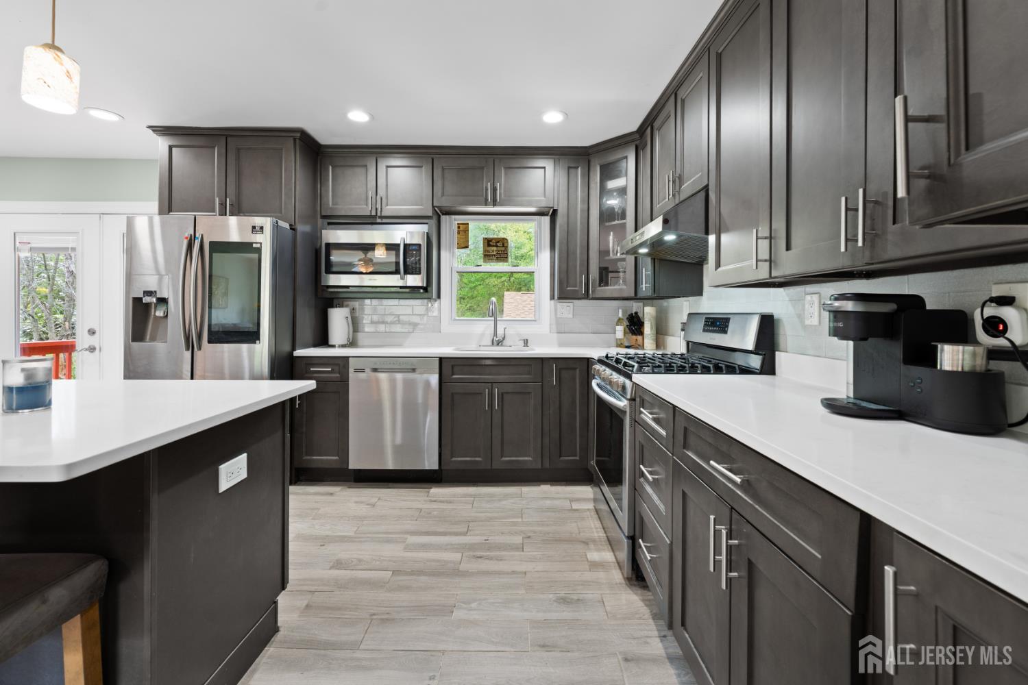 13 Fishel Road Edison, NJ 08820 - Photo 10 of 31 a kitchen with stainless steel appliances granite countertop a sink a stove and refrigerator