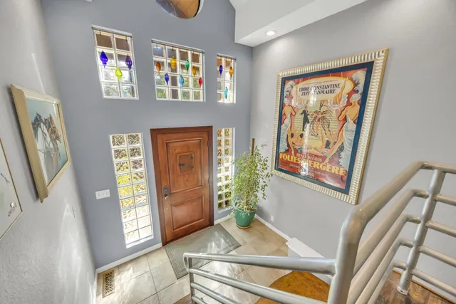 a living room with fireplace furniture and a floor to ceiling window