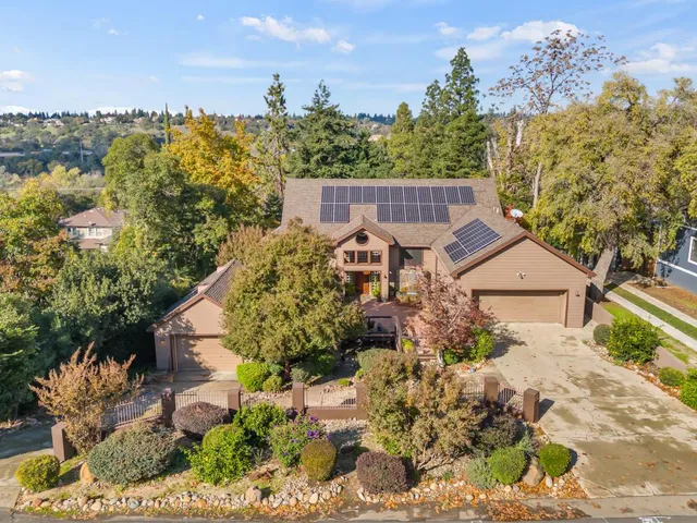 a view of a house with a yard and garden
