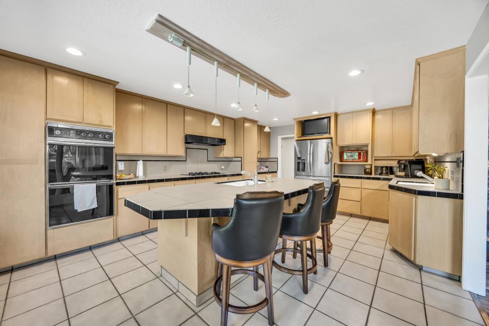 408 Sutter Street Folsom, CA 95630 - Photo 23 of 73 a kitchen with stainless steel appliances granite countertop a stove a sink a microwave a refrigerator and cabinets