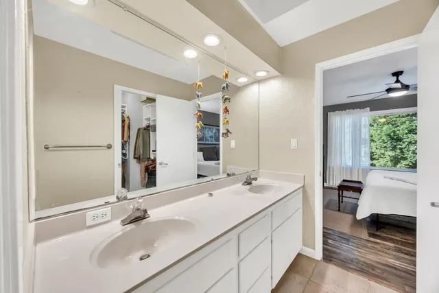 a spacious bedroom with a bed and a chandelier