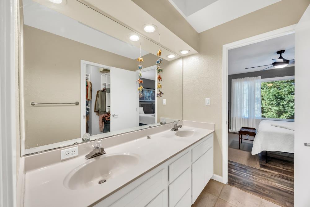 408 Sutter Street Folsom, CA 95630 - Photo 31 of 73 a bathroom with a double vanity sink large mirror and a bathtub