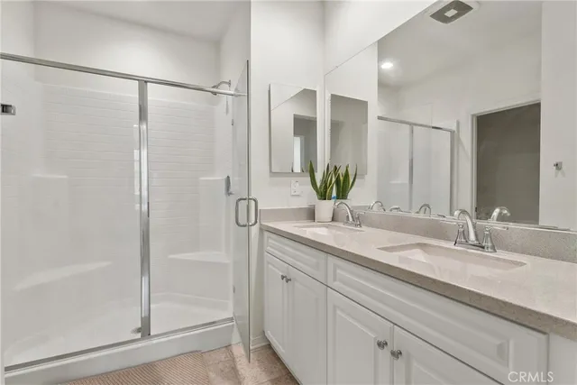 a bathroom with a shower sink and mirror
