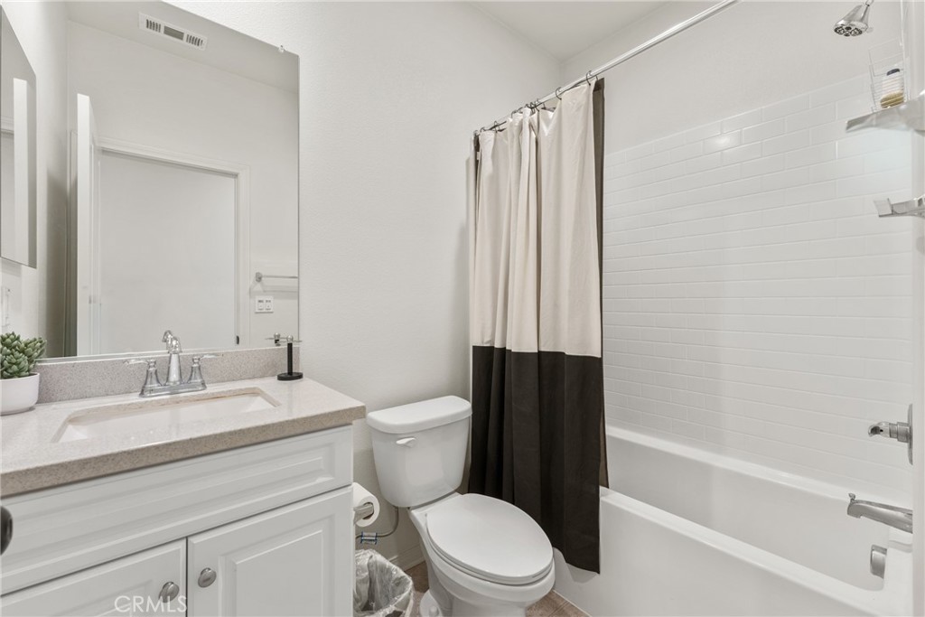2845 East Berry Loop Privado, Unit 33 Ontario, CA 91761 - Photo 13 of 17 a bathroom with a sink a toilet a mirror and shower