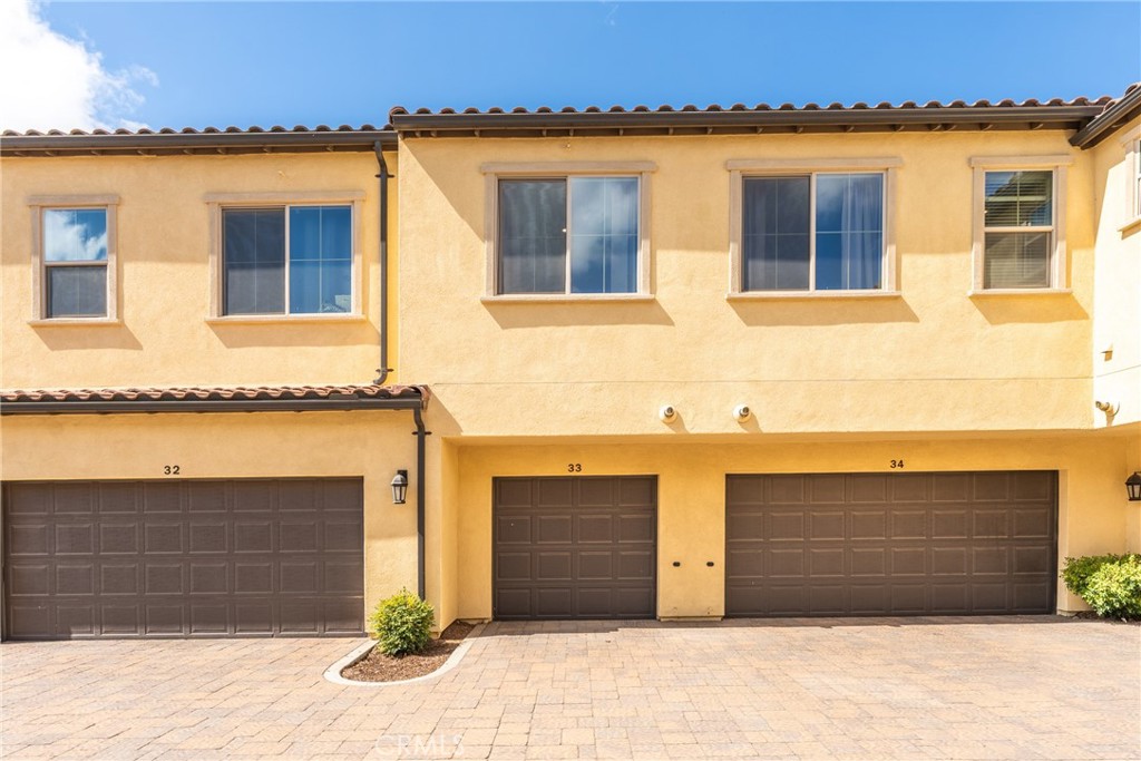 2845 East Berry Loop Privado, Unit 33 Ontario, CA 91761 - Photo 14 of 17 a front view of a house