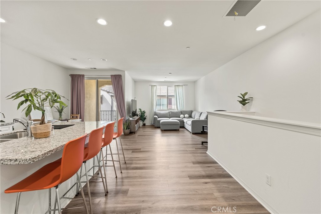 2845 East Berry Loop Privado, Unit 33 Ontario, CA 91761 - Photo 6 of 17 a living room with fireplace furniture and a wooden floor