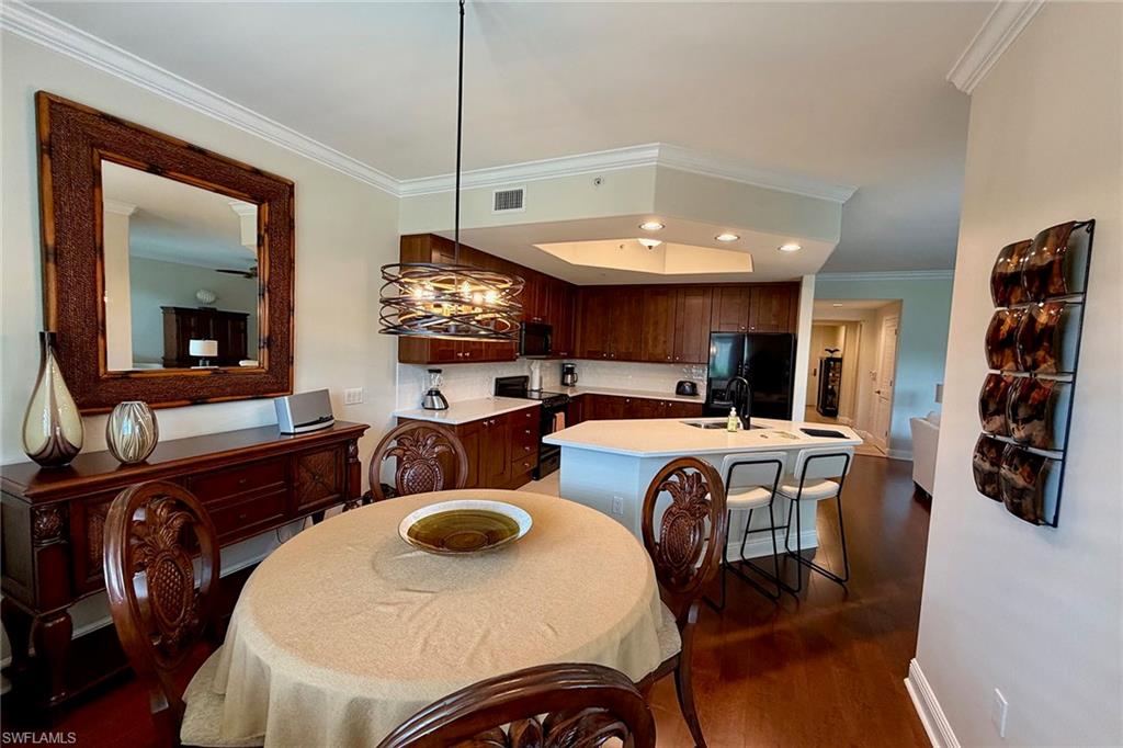 1015 Sandpiper Street, Unit D105 Naples, FL 34102 - Photo 11 of 39 a view of a dining room with furniture