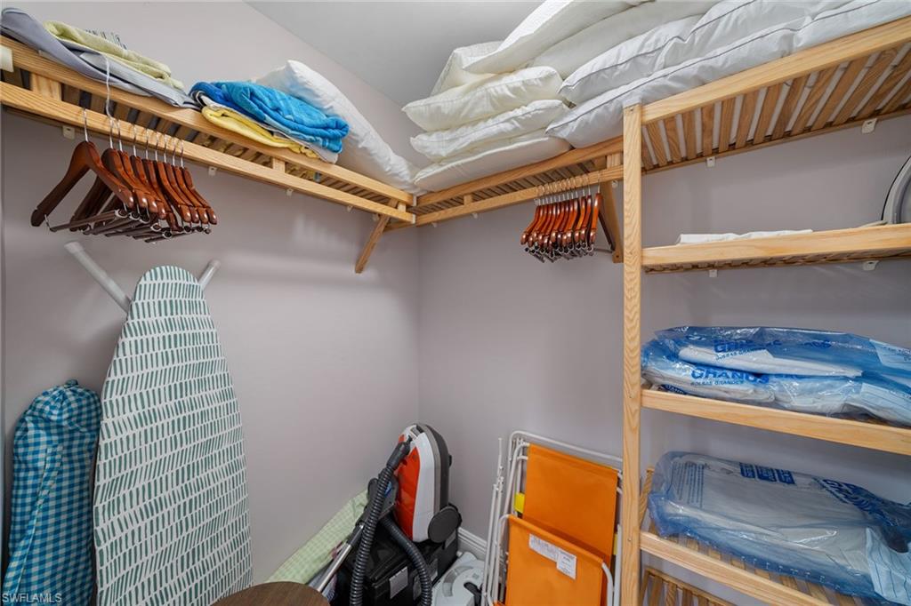 1015 Sandpiper Street, Unit D105 Naples, FL 34102 - Photo 20 of 39 a view of walk in closet with clothes and shoes