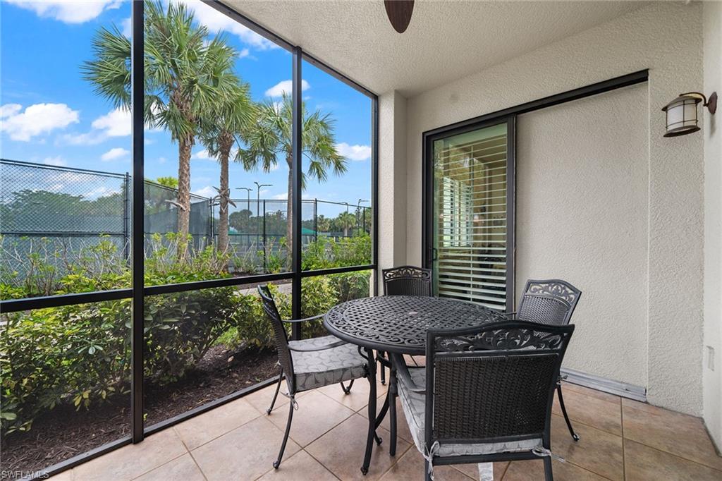1015 Sandpiper Street, Unit D105 Naples, FL 34102 - Photo 26 of 39 a view of a balcony with table and chairs