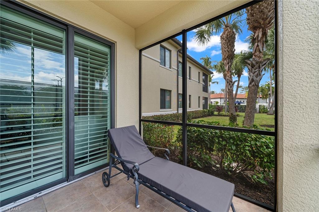 1015 Sandpiper Street, Unit D105 Naples, FL 34102 - Photo 27 of 39 a view of a chair and table in the balcony