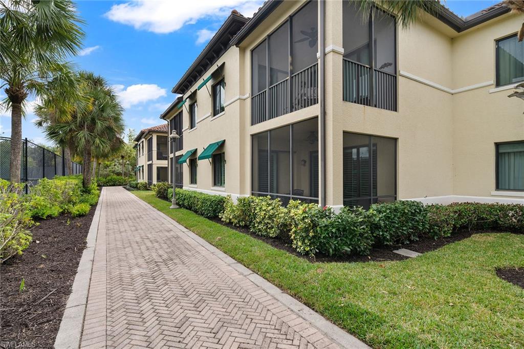 1015 Sandpiper Street, Unit D105 Naples, FL 34102 - Photo 29 of 39 a view of a building with a yard