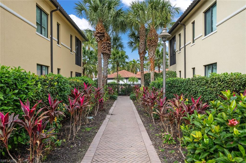 1015 Sandpiper Street, Unit D105 Naples, FL 34102 - Photo 31 of 39 a view of a pathway with house on both side