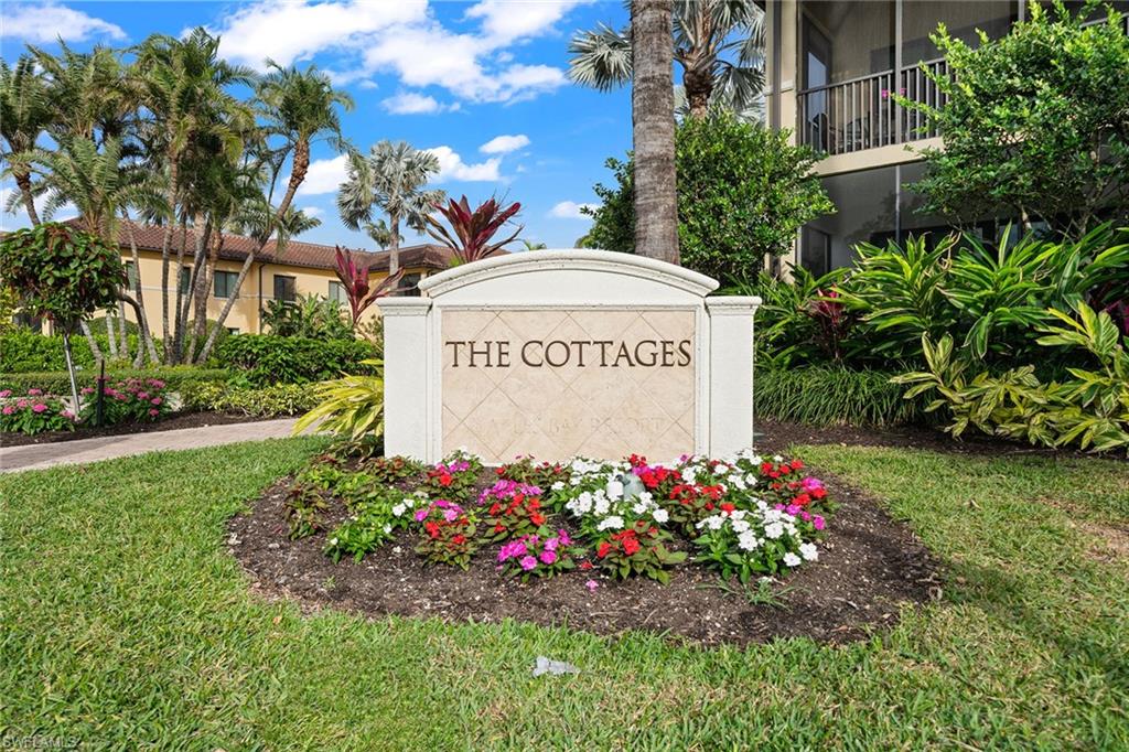 1015 Sandpiper Street, Unit D105 Naples, FL 34102 - Photo 34 of 39 a sign on the side of the road