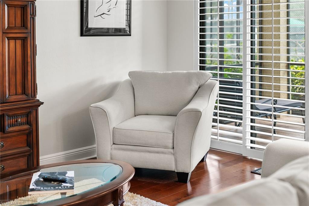 1015 Sandpiper Street, Unit D105 Naples, FL 34102 - Photo 4 of 39 a living room with furniture and a wooden floor