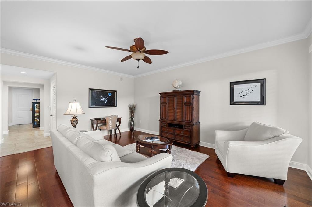 1015 Sandpiper Street, Unit D105 Naples, FL 34102 - Photo 6 of 39 a living room with furniture and a wooden floor
