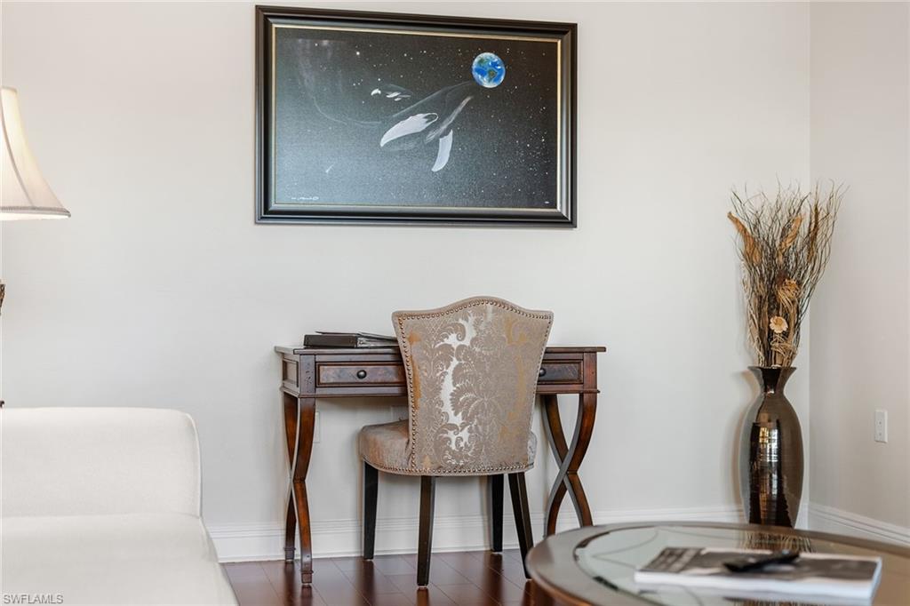 1015 Sandpiper Street, Unit D105 Naples, FL 34102 - Photo 7 of 39 a view of workspace with a wall paintings and a fireplace