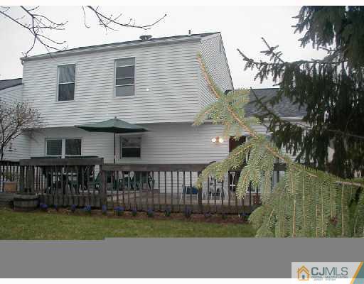 81 Woodbury Road Edison, NJ 08820 - Photo 8 of 8 a view of a house with a yard and potted plants