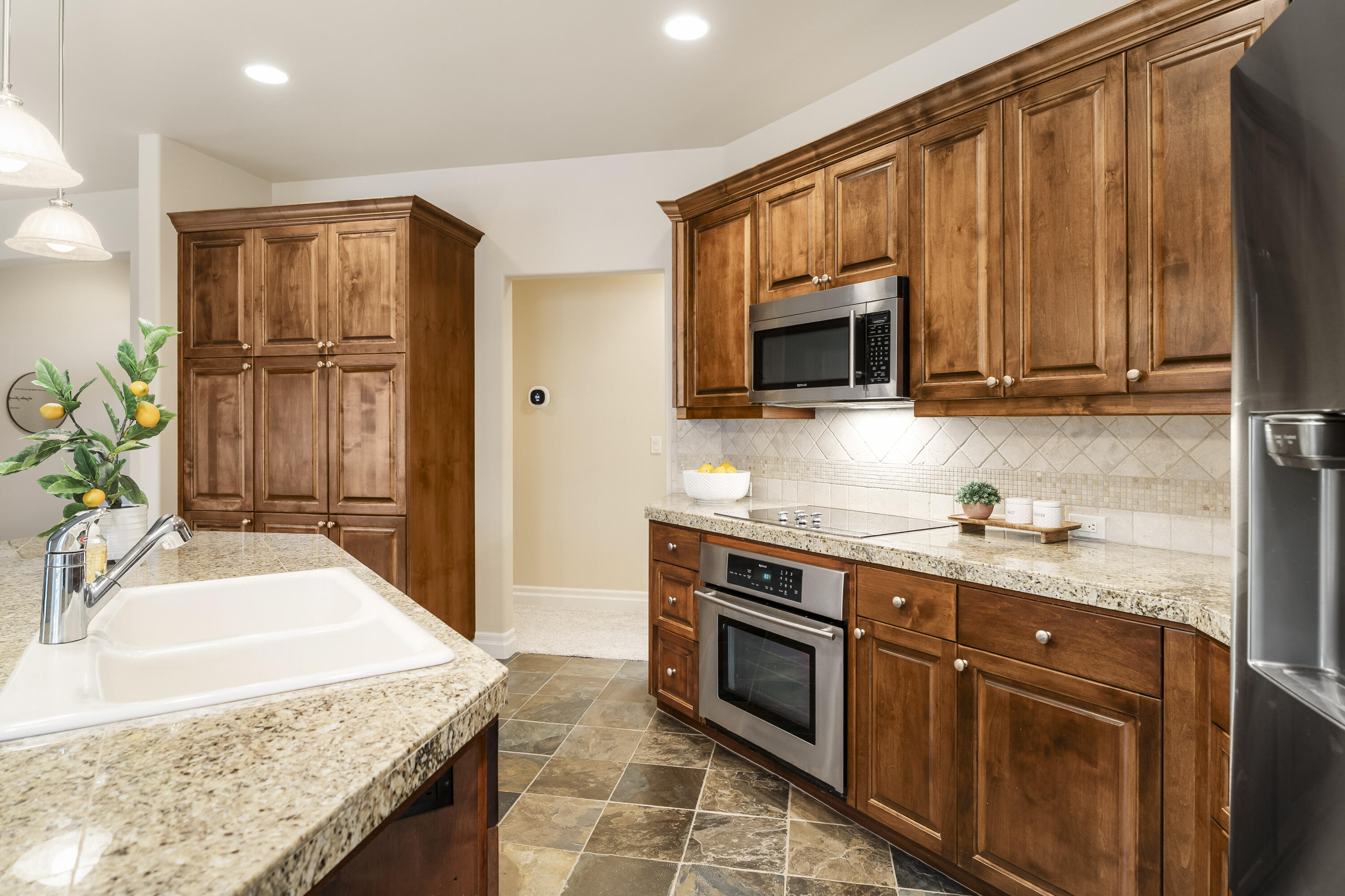 784 Ribbon Falls Road Redmond, OR 97756 - Photo 26 of 79 a kitchen with stainless steel appliances granite countertop a stove a sink and a microwave