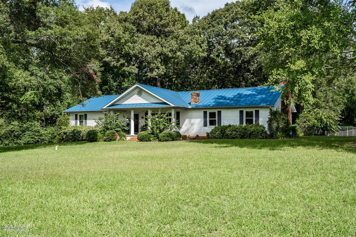 a front view of a house with a yard and porch