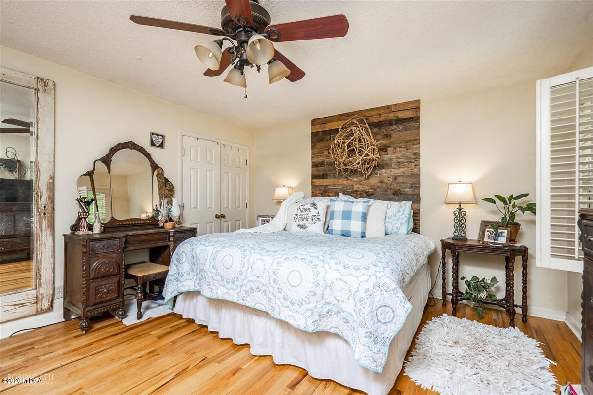2985 Graham Road Gray, GA 31032 - Photo 12 of 30 a bedroom with a bed a table and painting on the wall