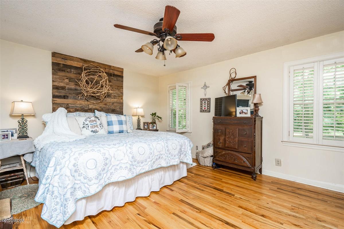 2985 Graham Road Gray, GA 31032 - Photo 13 of 30 a bedroom with a bed and wooden floor