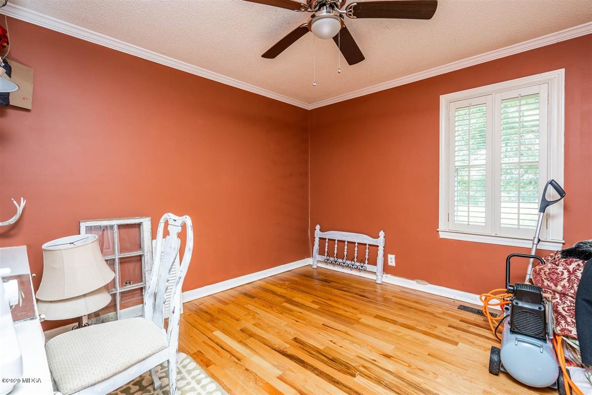 2985 Graham Road Gray, GA 31032 - Photo 15 of 30 a bedroom with a bed and a chair