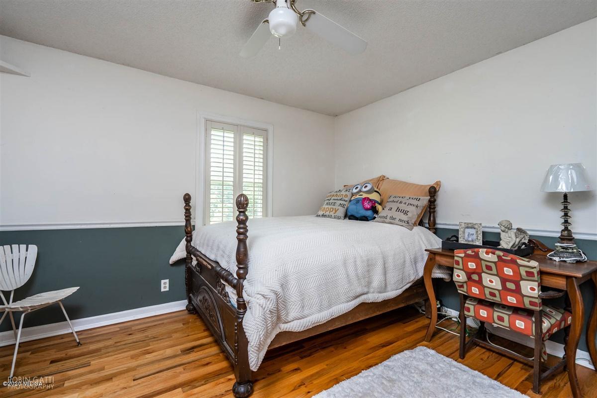2985 Graham Road Gray, GA 31032 - Photo 17 of 30 a bedroom with a bed and a chandelier