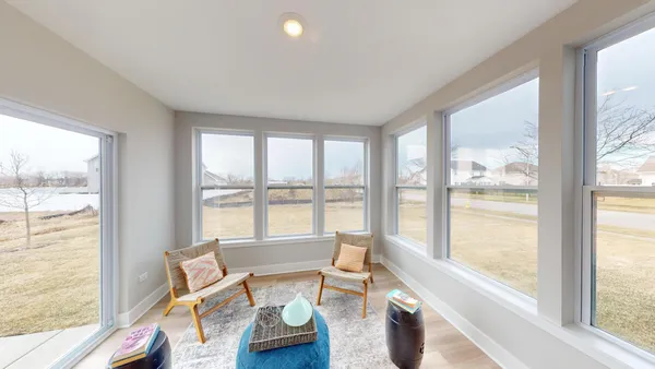 a living room with furniture and floor to ceiling windows