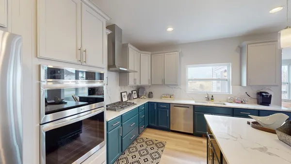 a large kitchen with a sink a counter space and appliances