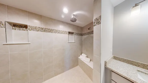 a bathroom with a mirror and a shower