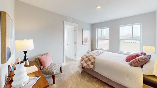 a bedroom with two beds and a couch