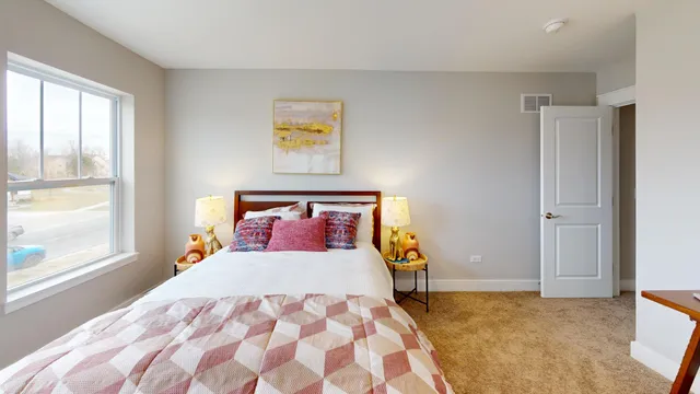 a bedroom with a bed and a painting on the wall