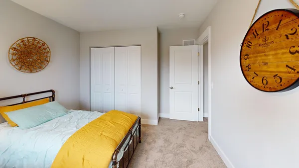a bed room with a bed and a chair