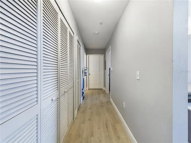 a view of a hallway with wooden floor